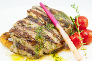 Grilled steak with sauce and greens on white background