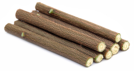 Medicinal neem twigs over white background