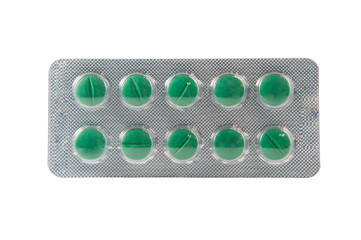 Green tablet in transparent blister pack