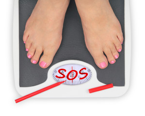 Woman' s feet on bathroom scale