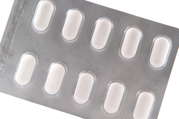 Long white tablet in transparent blister pack