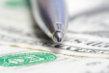 ballpoint metal pen on US dollar bill