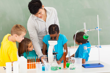 primary teacher and students in science class