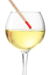 Glass of wine with thermometer, isolated on white