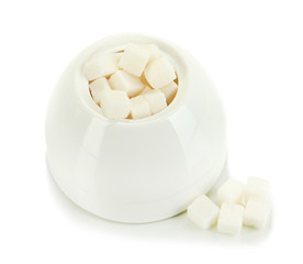 Refined sugar in white sugar bowl on grey background