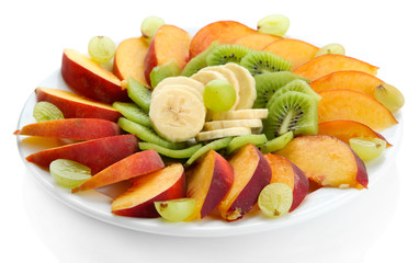 Assortment of sliced fruits on plate, isolated on white