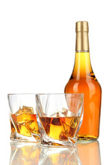 Glasses of whiskey with bottle, isolated on white