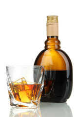 Glass of liquor with bottle, isolated on white