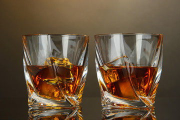 Glasses of whiskey, on dark background