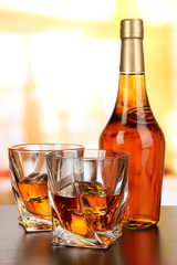Glass of whiskey with bottle, on dark background