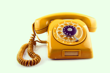 old Orange telephone with rotary dial