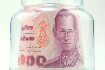 Thai money in the glass bottle
