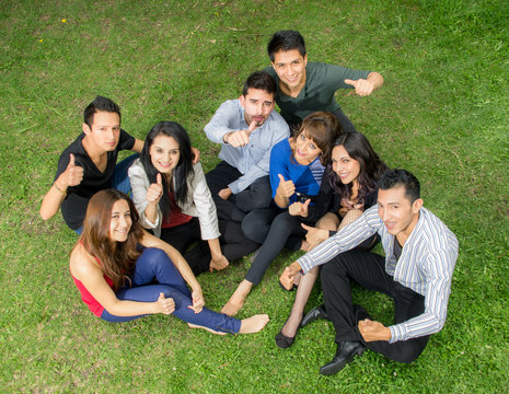 Group of hispanic teens thumbing up outdoors