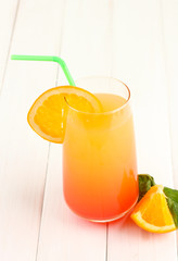 Glass of multicolor cocktail on white background