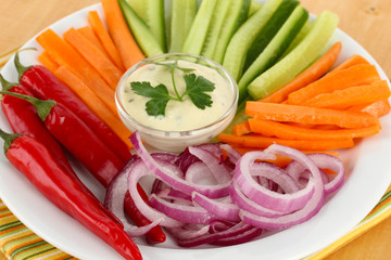 Assorted raw vegetables sticks in plate close up