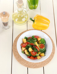 Light salad in plate on wooden table