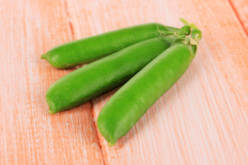 Sweet green peas on wooden background