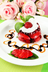 Tasty jelly dessert with fresh berries, on pink roses