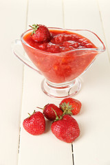 Homemade strawberry jam, on color wooden background