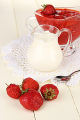 Homemade strawberry jam, on color wooden background