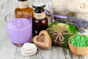 Still life with lavender candle, soap, massage balls, bottles,