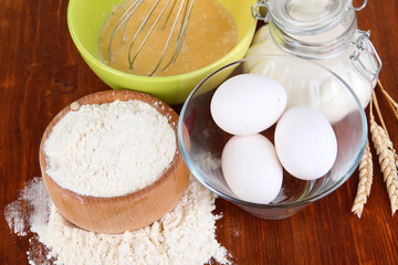 Ingredients for dough on wooden table close-up