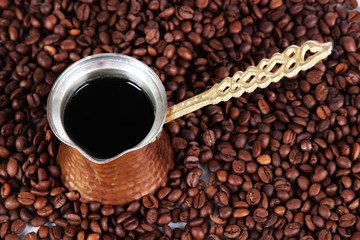 Coffee pot on coffee beans background