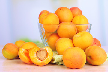 Fresh natural apricot in bowl on table in kitchen