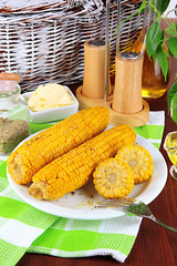 Flavored boiled corn on  plate on wooden table close-up