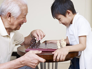 grandpa and grandson playing chess