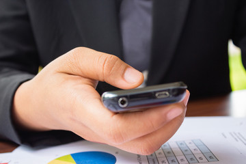 Flat cell phone in business man hand