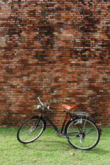Fototapeta na wymiar Vintage bicycle and red brick wall