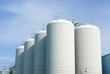 brewery tanks blue sky big containers beer production industry