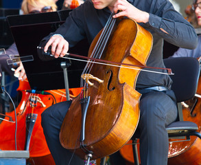 Fototapeta premium close-up of cellos being played in a concert