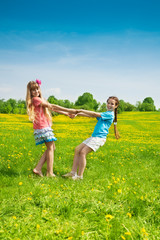 Naklejka na ściany i meble Girls dancing in the flower field
