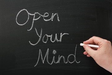 Writing Open Your Mind on a blackboard