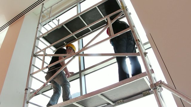 Construction workers on scaffolding