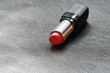 a lipstick on leather floor