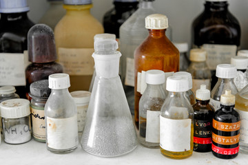 Photo of an old laboratory with a lot of bottles