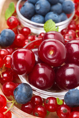 close-up of bowl of cherries and assorted fresh berries