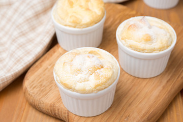 peach souffle in the portioned form on a wooden board, top view