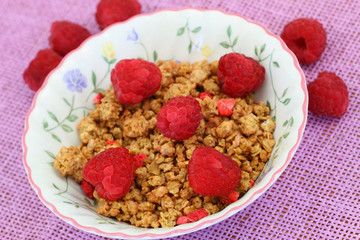 Breakfast cereal with fresh raspberries, close up