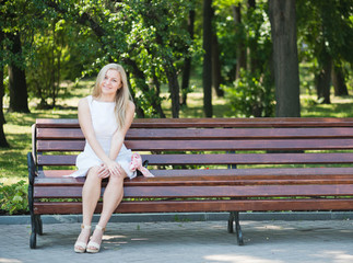 Young woman sitting on the bench in park