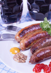 beer and sausages on a plate