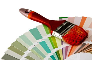Close-up of a color palette and a brush on white background