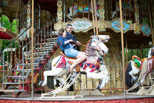 Couple having fun on merry-go-round
