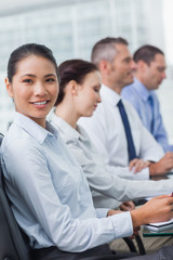 Fototapeta premium Cheerful employee attending presentation with her colleagues