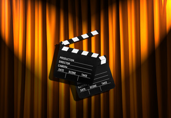 Movie clapper board against curtain