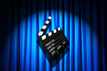 Movie clapper board against curtain