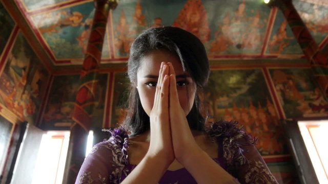 Asian girl praying in temple, wat, pagoda, Phnom Penh, Cambodia